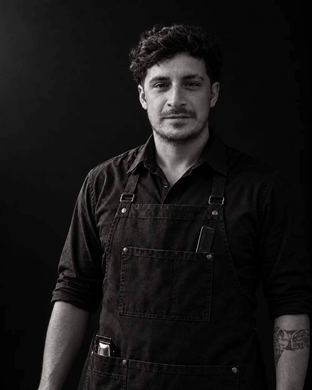 Leo, the barber behind EL BARDO, in a black-and-white portrait.